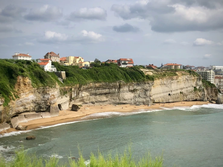 the beach is next to the cliffs and homes