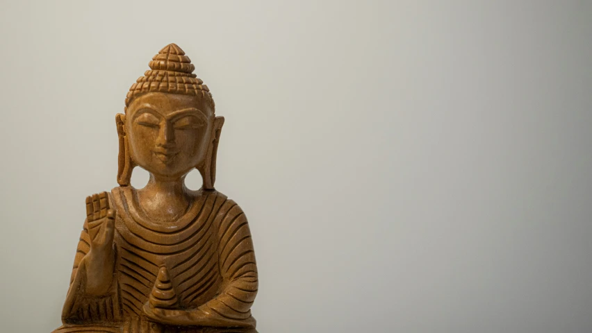 an indian wood carving statue with white background