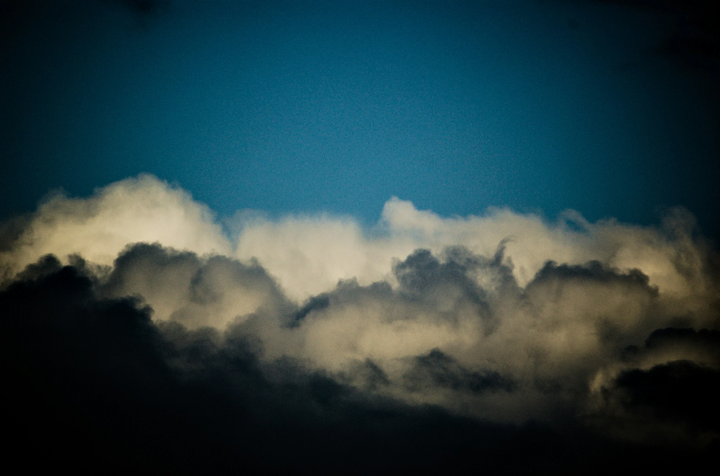 a large plane flying above the clouds in the sky