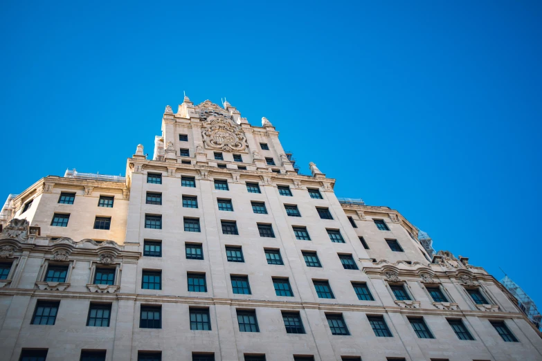 the top of a white building against a blue sky