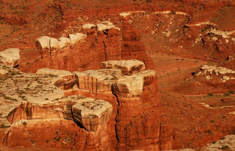 the red dirt area features a rock formation and large mounds