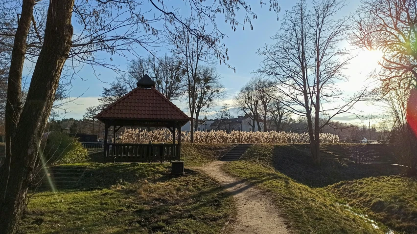 a path that runs into a park with a gazebo