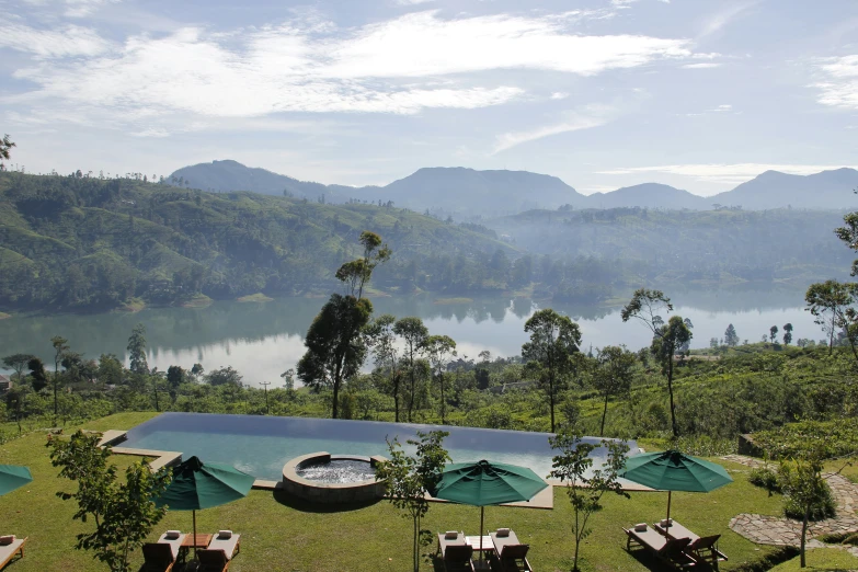 the lawn chairs are beside the swimming pool with view