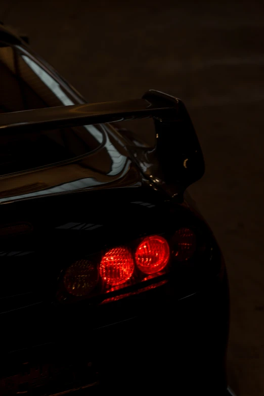 the back light of a black car with its ke lights on