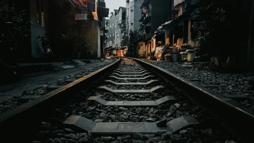 a train track in an alley way between buildings