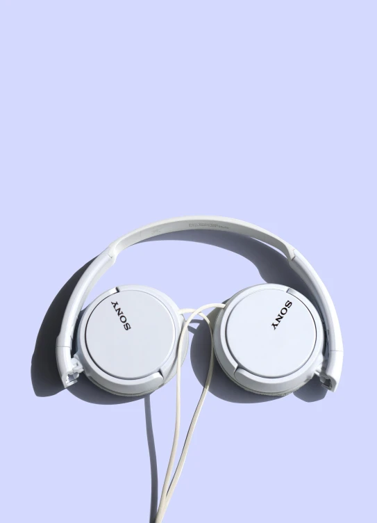 white headphones against a light blue background