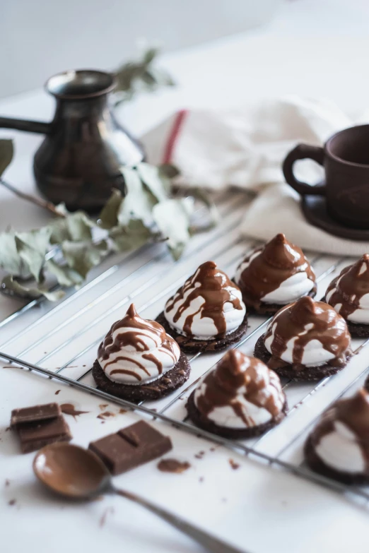 cupcakes on a cooling rack with chocolate topping