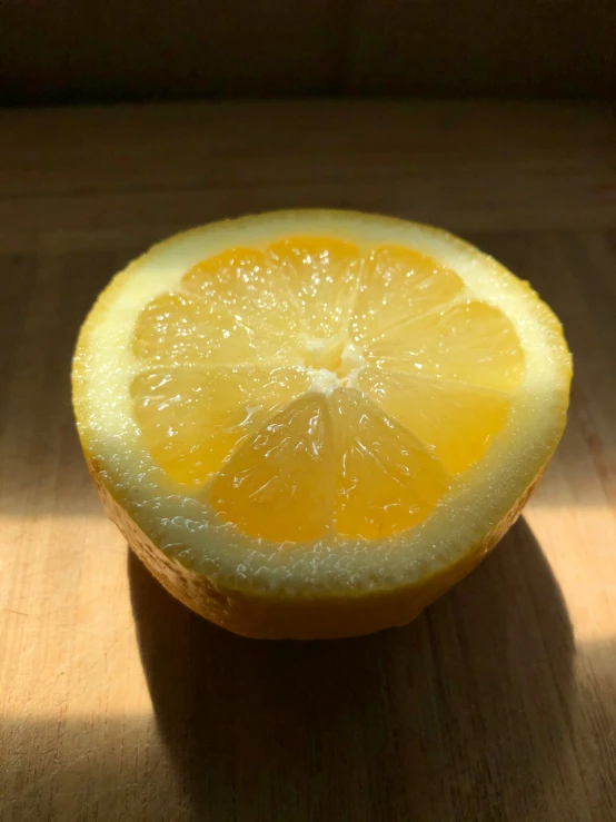 a fresh lemon sits on a table top