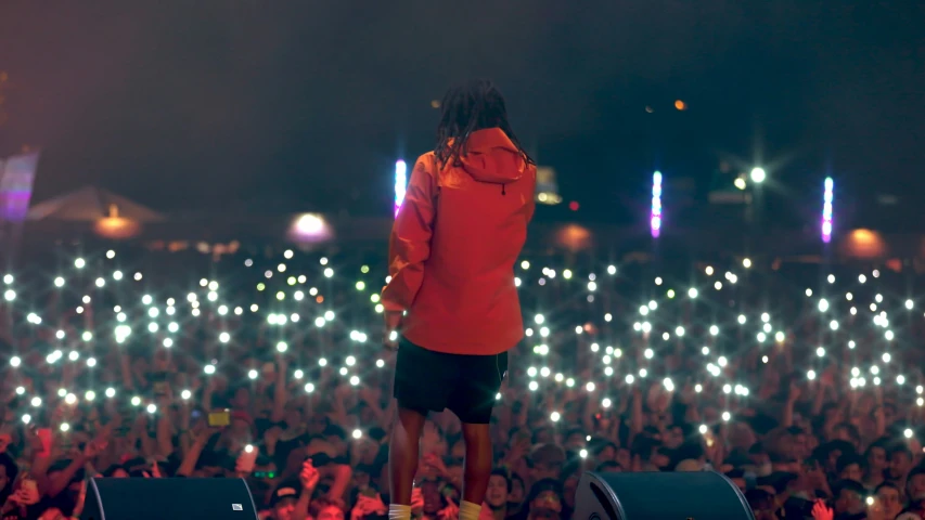 a person standing on stage with lights in the background