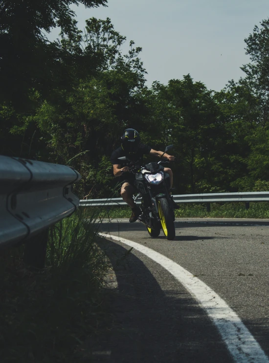 a motorcyclist on a curvy road going around curve