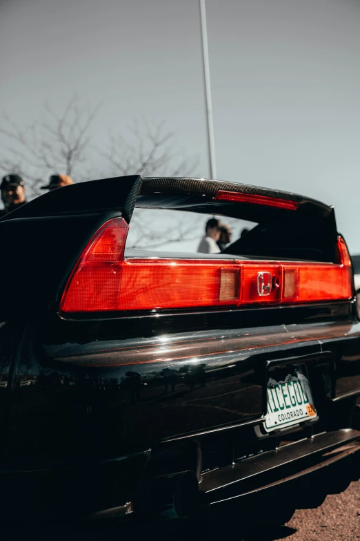 a closeup of the tail lights and trunk of an automobile