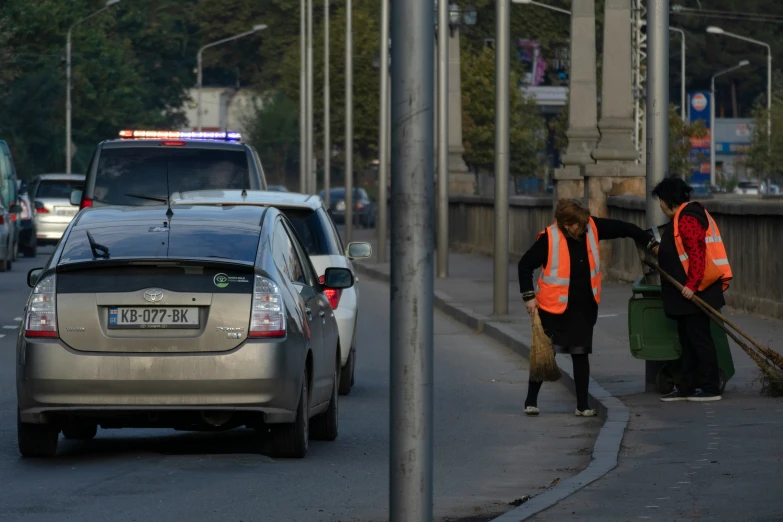 two men that are standing near a car