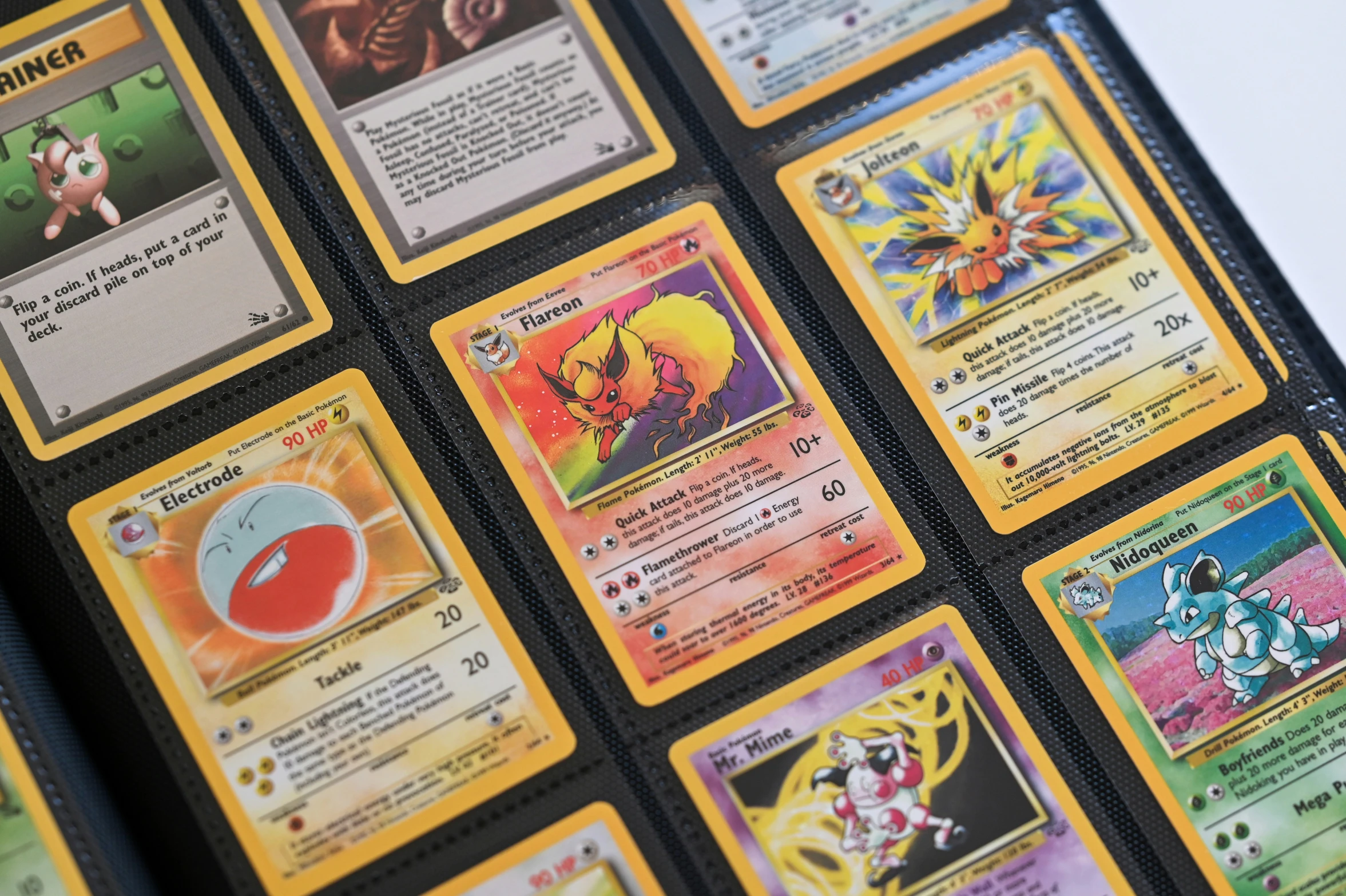 an array of pokemon cards on a table