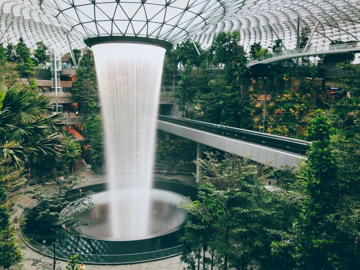 a very tall, tall waterfall with trees around it