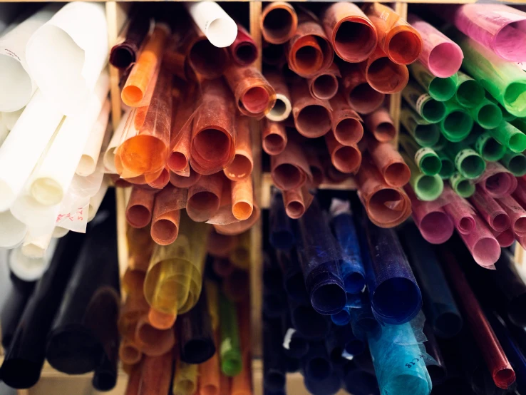 a collection of colored pipe handles on a rack