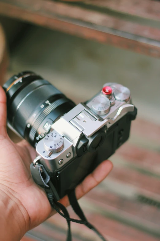 a person holding a camera up with their hand