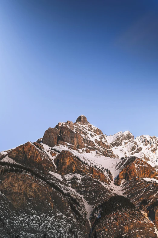 there is a snowboarder jumping high in the air on this snowy mountain