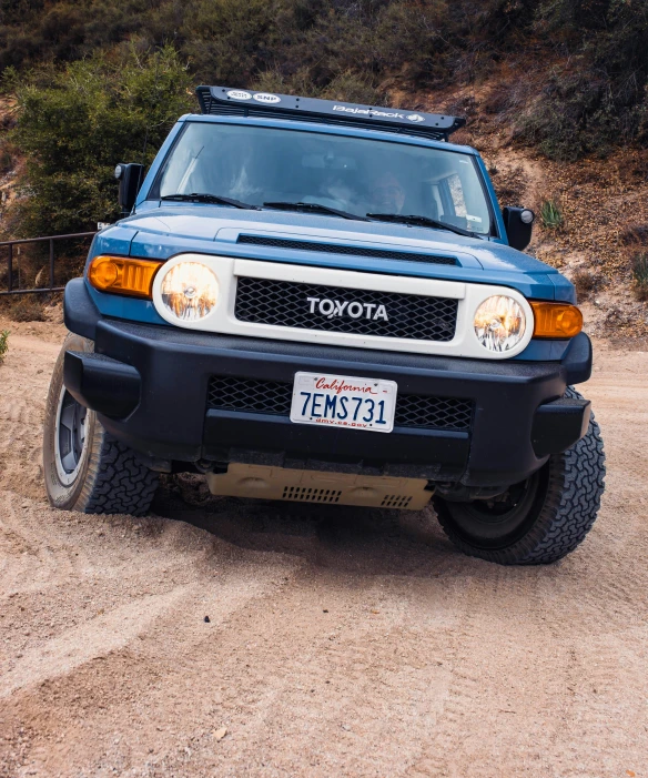 the front end of a blue pickup truck