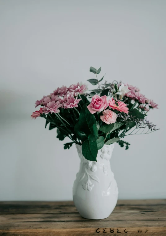 a bunch of flowers in a vase on a table