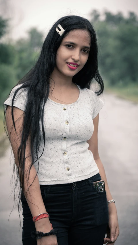 young lady wearing white and black posing with long hair