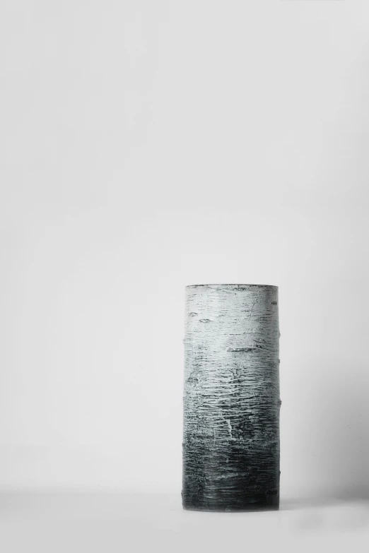 black and white image of a round vase with water on the bottom