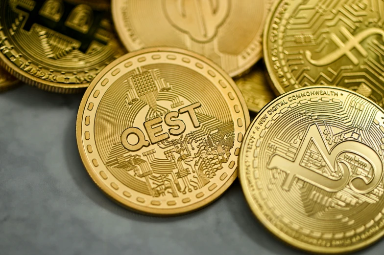 a pile of different types of coin sitting on a table