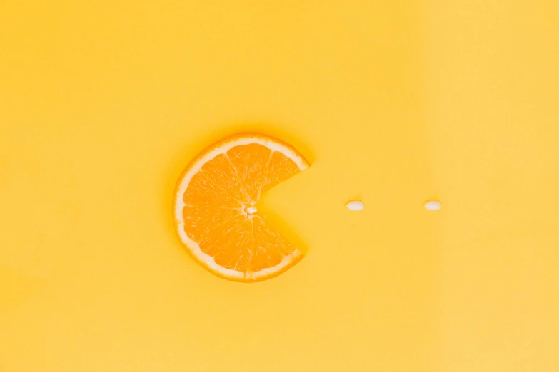 a piece of orange fruit, showing the peel and some seeds