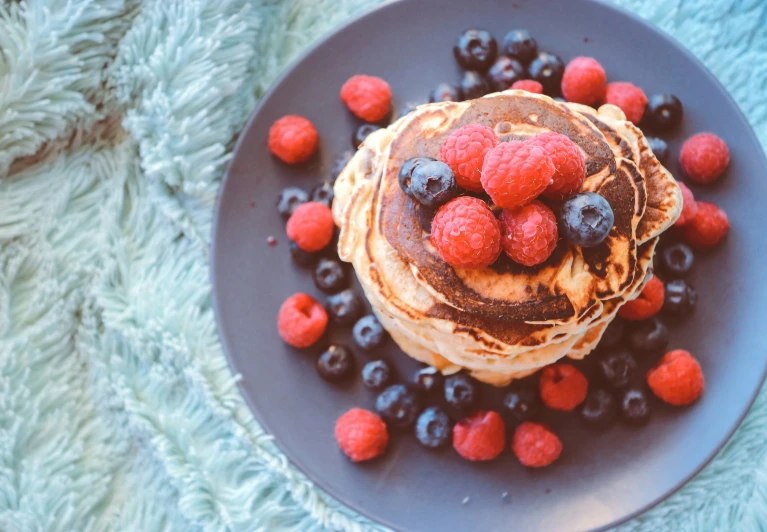 some blueberries and strawberries are on a plate