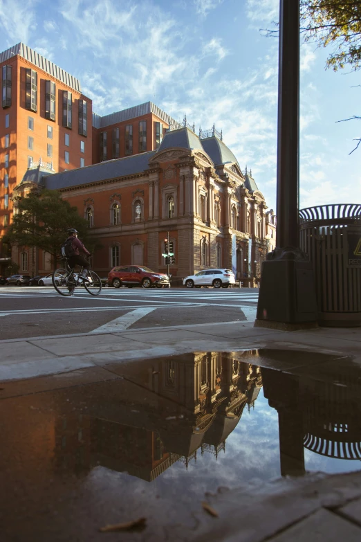 water is flowing in the street beside an old building