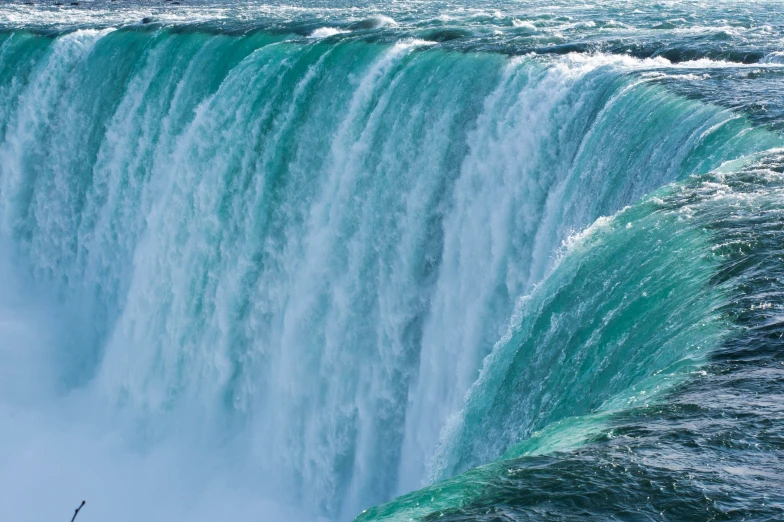 a large waterfall on top of the ocean