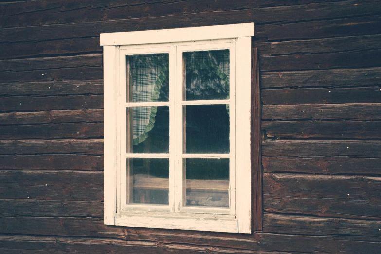 a window is set into the wall of a house