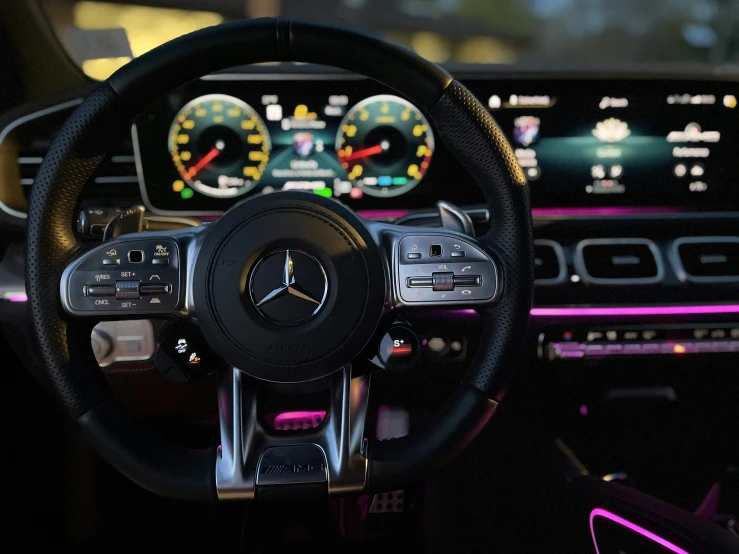 the dashboard of a modern car with steering wheel controls