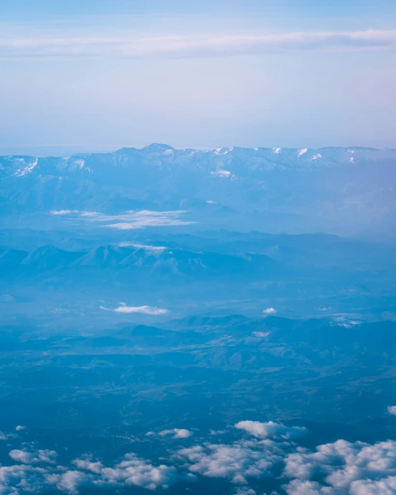 the view from the airplane is overlooking mountains