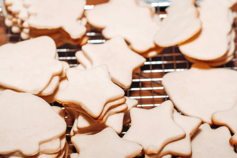 many small and large cookie pieces baking on a rack