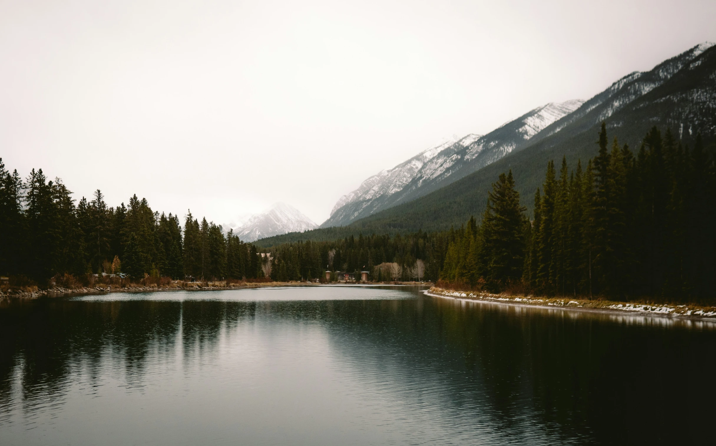 a mountain lake in front of tall mountains