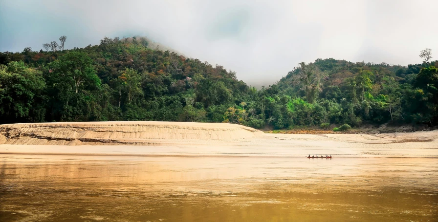 a small boat glides down the river