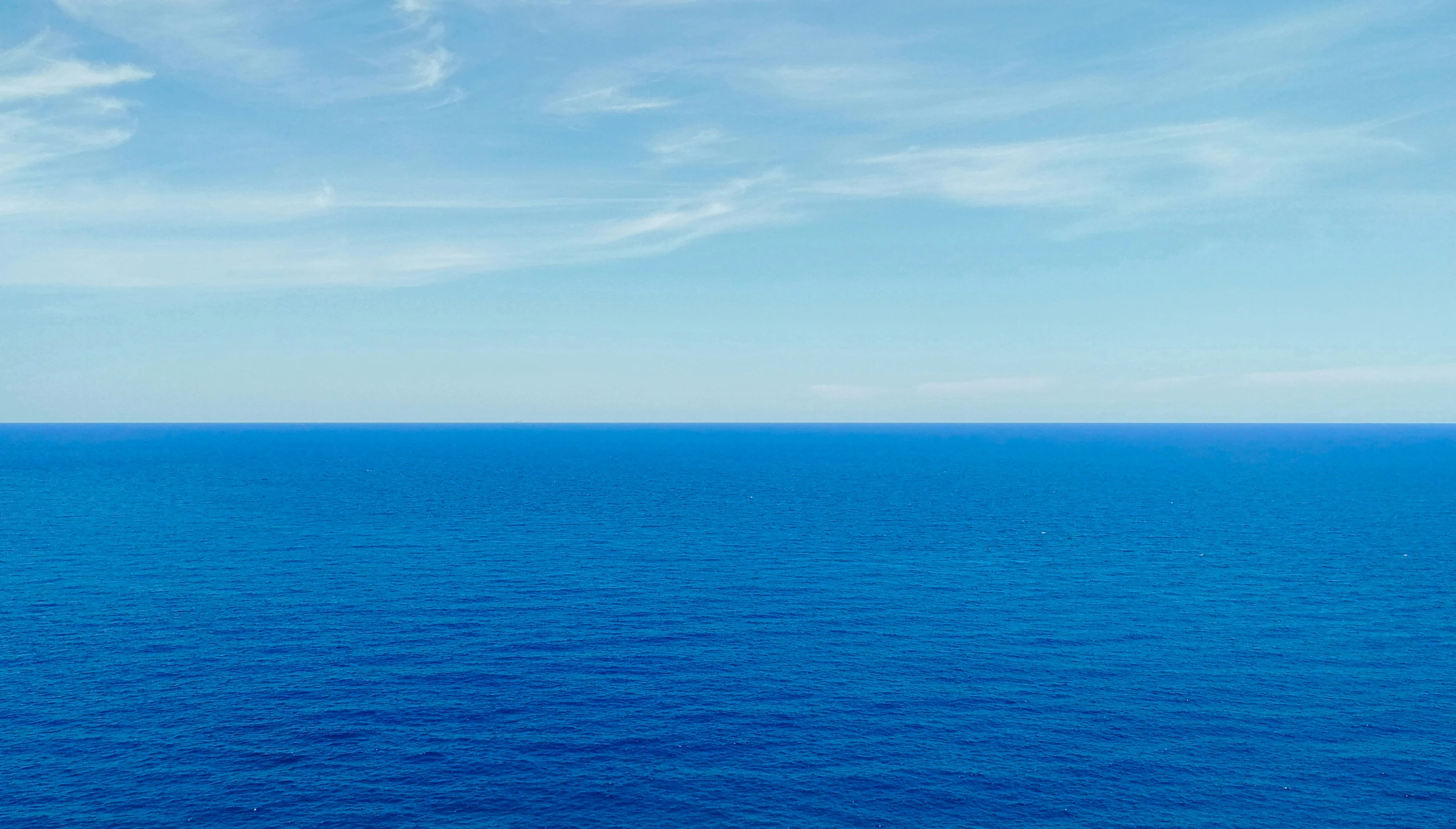 the ocean with a boat out in the water