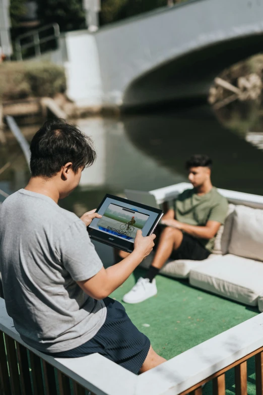 two people are sitting on a boat playing video games