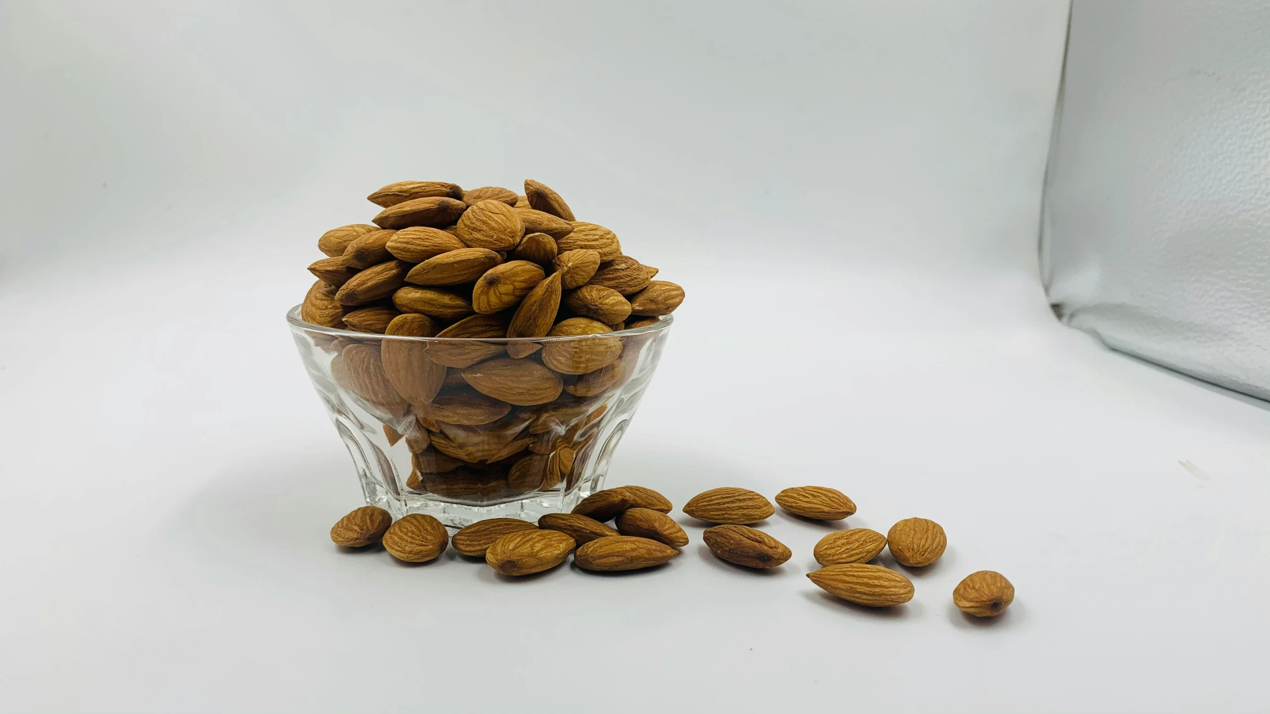 nuts in a glass bowl on a white background