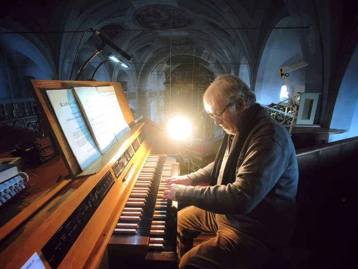 a man that is sitting in front of a keyboard