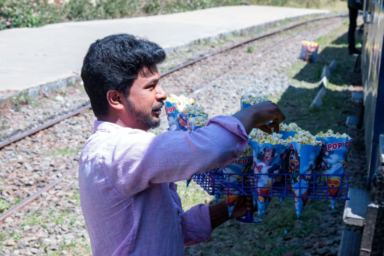 a man holding up a basket of donuts