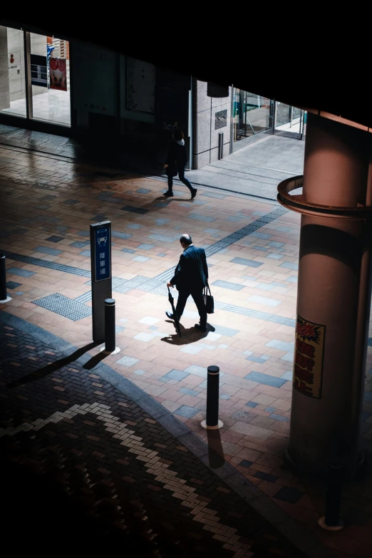 the man is walking with his luggage in tow