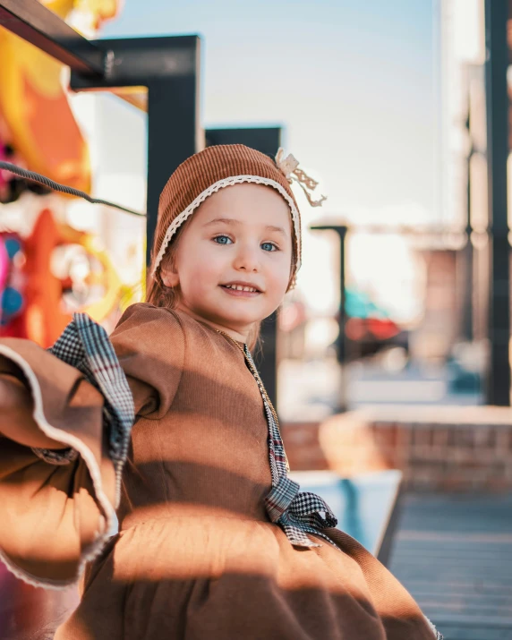 a little girl posing on a bench in a clothing store