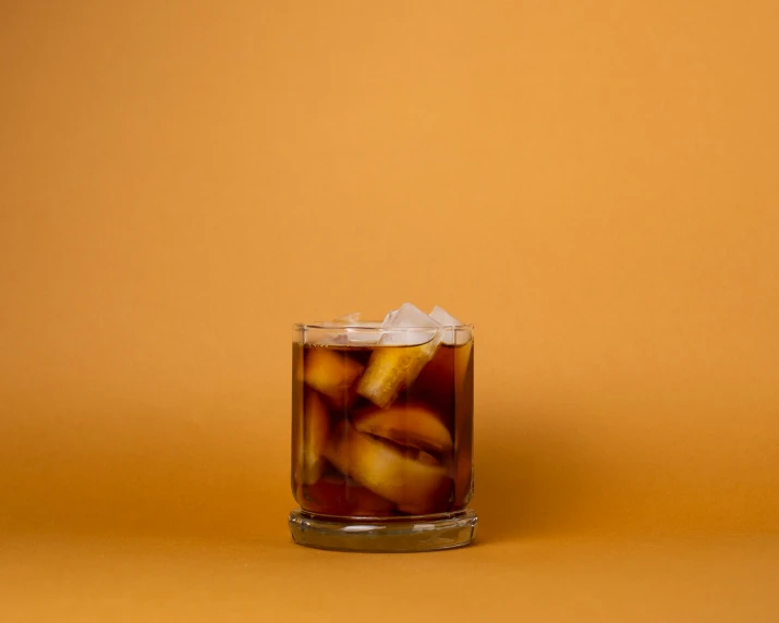 there is a glass filled with iced drinks on the table