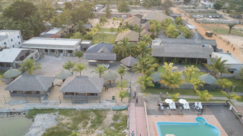 an aerial view of a home with palm trees and pool