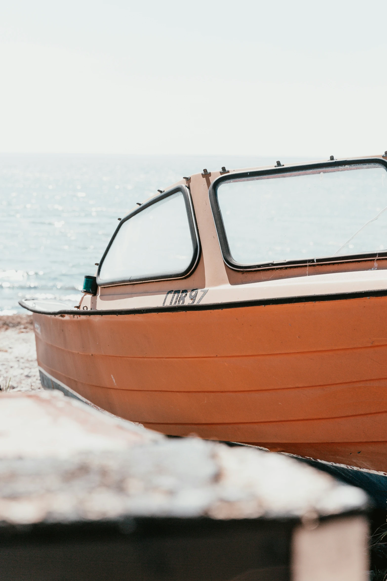 a small boat is parked on the sand