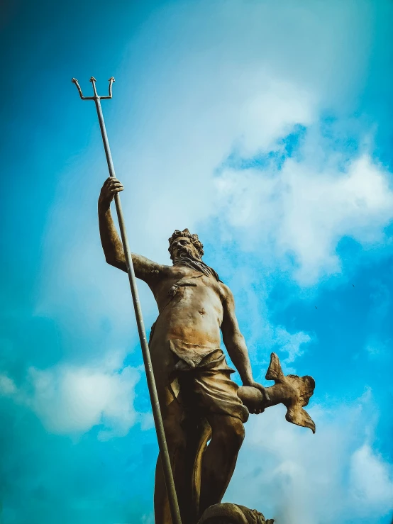 the statue of a man is on top of a rock with a bird