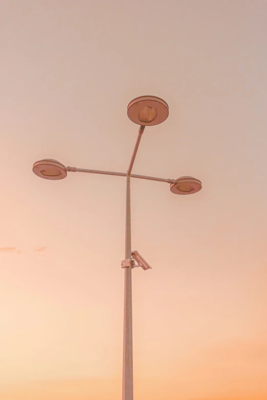 a couple of street lights hanging from the side of a pole