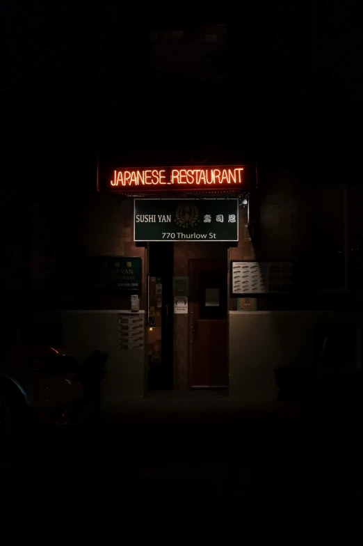 a sign that reads japanese restaurant in the dark