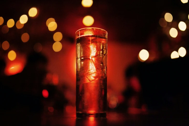 closeup of glass container with lite candle inside of room